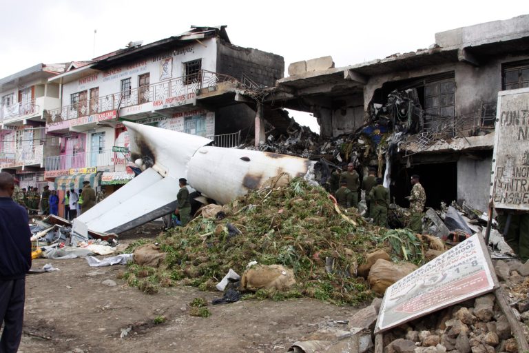 A pile of mild stimulant drug Khat llies beside the wreckage of a Fokker 50 cargo plane after it crashed into a building on take-off at Kenyatta International Airport, in Nairobi, Kenya, Wednesday, July 2, 2014. According to a police official said Joseph Ngisa, the airport's head of police investigations, four people aboard the plane were killed when their cargo plane crashed, transporting the mild stimulant drug known as Khat to the Somali capital of Mogadishu. (AP Photo/Khalil Senosi)