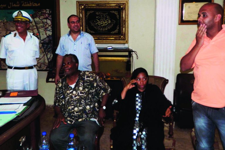 FILE - In this Monday, July 16, 2012 file photo, Rev. Michel Louis, 61, left, and 39-year-old Lissa Alphonse, second right, rest after their release at a police station after being held hostage by Bedouins in El Arish, in the northern part of Egypt's Sinai Peninsula. In Egypt's restive Sinai, Bedouin leaders are pushing to take matters in their own hands and urging the government to arm their tribesmen to help keep security in the peninsula, where the state is struggling to rein in rampant lawlessness and uproot Islamic militants who have attacked Egyptian troops and neighboring Israel. But the proposal, which the government says it is considering, raises fears that the Bedouin could become a new militia, only adding to the turmoil in the peninsula. (AP Photo, File)