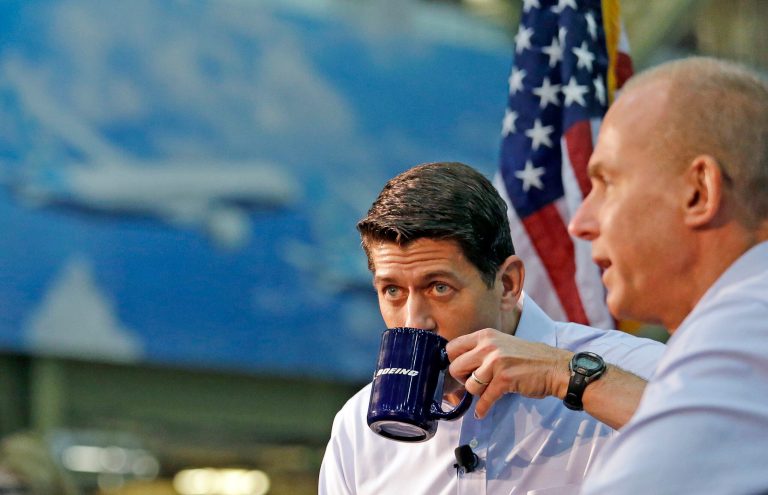 House Speaker Paul Ryan, left, sips from a Boeing mug as he sits with the Boeing Co. CEO Dennis Muilenburg Thursday, Aug. 24, 2017, in Everett, Wash. Ryan toured the factory before speaking with and taking questions from some workers there, mostly on tax reform. (AP Photo/Elaine Thompson)