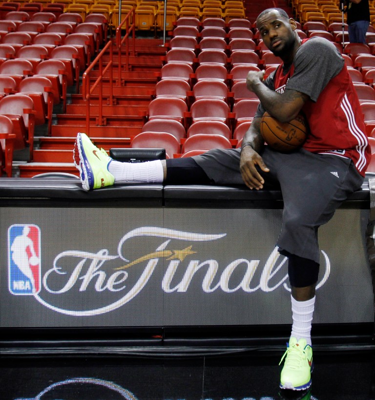   Miami Heat small forward LeBron James takes a break on the scorer's table during practice, Monday, June 18, 2012, in Miami. The Heat play the Oklahoma City Thunder in Game 4 of the NBA basketball finals on Tuesday. (AP Photo/Alan Diaz)  