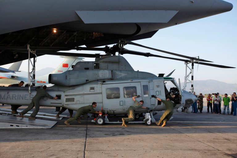 US soldiers unload Huey helicopters from a US Air Force Boeing C-17 Globemaster III after the same landed at the Tribhuvan International Airport in Kathmandu, Nepal, Sunday, May 3, 2015. (AP Photo)