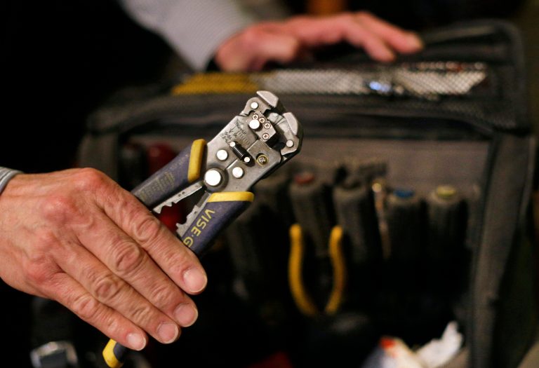 In this Jan. 10, 2014, photo, Stan Osnowitz, an electrician with 43 years of experience, displays tools from his work bag in his apartment in Baltimore. He has been unemployed since the end of June 2013 and lost his state unemployment benefits of $430 a week in December, but he keeps his work equipment packed and ready to go at a moment's notice. (AP Photo/Patrick Semansky)