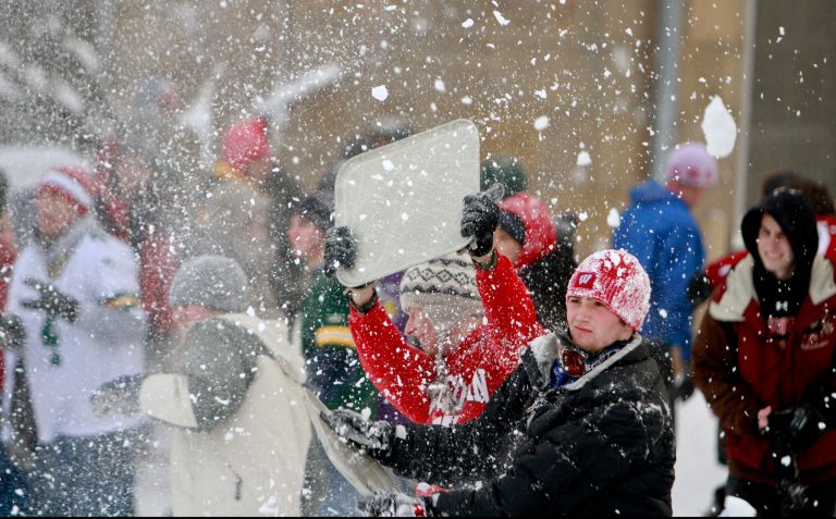MADISON, WISCONSIN - DECEMBER 9:  Tyler Spriggs, right, a junior at the University of Wisconsin-Madison, battles in a campus-wide snowball fight on Bascom Hil December 9, 2009 in Madison, Wisconsin. (Photo by Andy Manis/Getty Images)