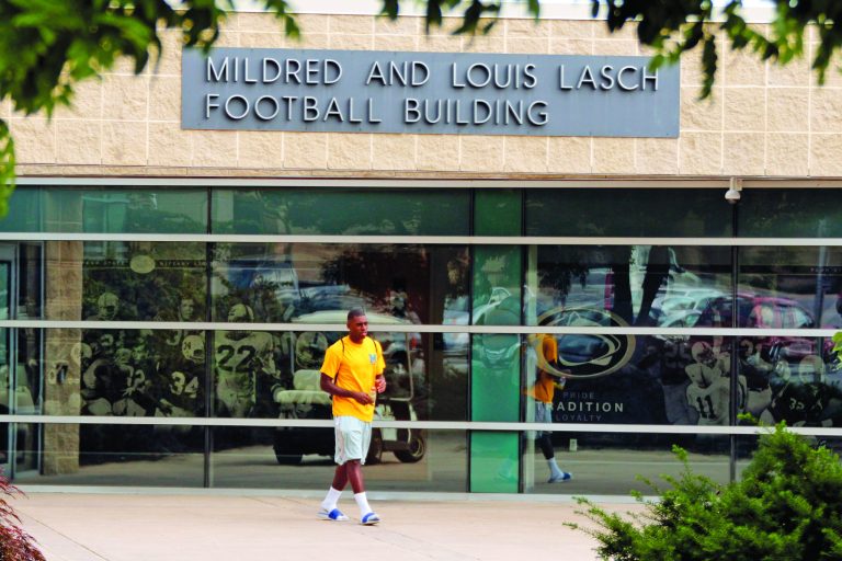 FILE - In this July 12, 2012 file photo, a Penn State student leaves the Mildred and Louis Lasch Football Building on the Penn State University main campus in State College, Pa. After and eight-month inquiry, Former FBI director Louis Freeh's firm produced a 267-page report that concluded that Paterno and other top Penn State officials hushed up child sex abuse allegations against former Penn State assistant football coach Jerry Sandusky for more than a decade for fear of bad publicity, allowing Sandusky to prey on other youngsters. (AP Photo/Gene J. Puskar, File)