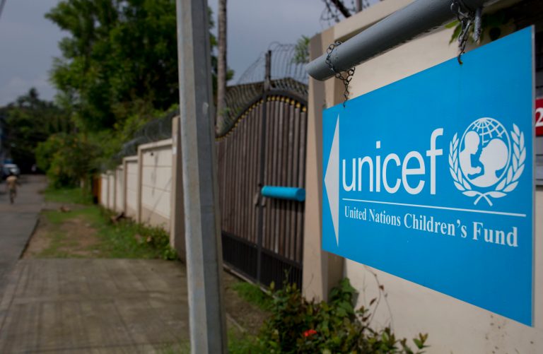 A newly placed sign board gives directions to the office of United Nations' children's agency, in Yangon, Myanmar, Friday, May 23, 2014. UNICEF defended a decision to pay nearly $90,000 a month for its new office owned by the family of an ex-army general who spent years on a U.S. sanctions during Myanmar's dictatorship. (AP Photo/Gemunu Amarasinghe)