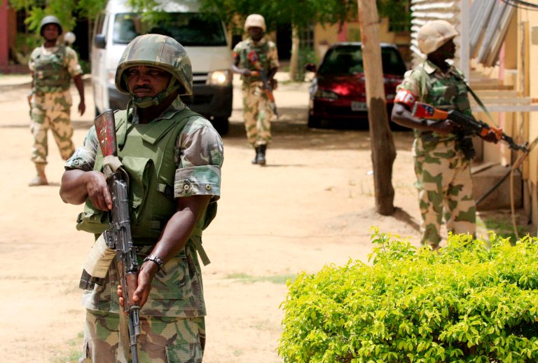 Nigerian soldiers stand guard at the offices of the state-run Nigerian Television Authority in Maiduguri, Nigeria. (AP/Jon Gambrell)