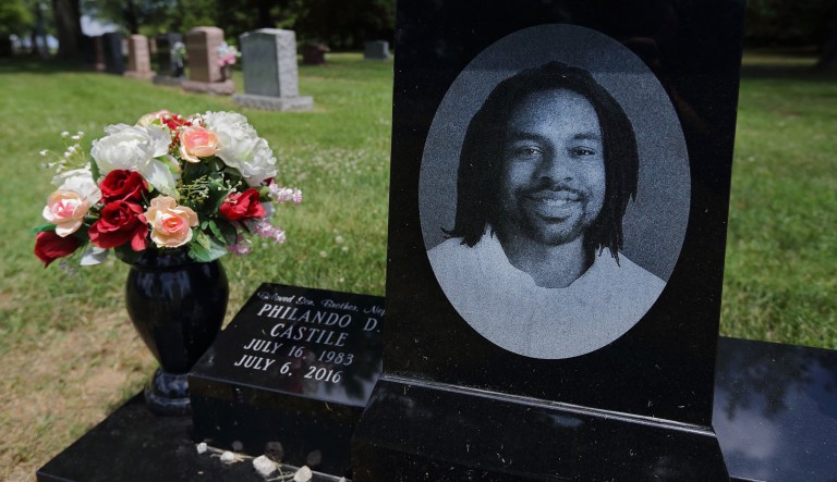 A bouquet of flowers adorns the grave of Philando Castile on the one-year anniversary of his death in St. Louis. Minnesota governor has proposed that a new police training fund be named in honor of Castile. (David Carson/St. Louis Post-Dispatch via AP)