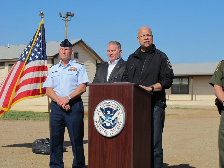 U.S. Homeland Security Secretary Jeh Johnson addresses reporters after touring a new family immigration detention center in Dilley, Texas, on Monday, Dec. 15, 2014. Opening following a summer surge of children crossing the U.S.-Mexico border illegally, the compound features cottages and will have an initial capacity of 480 growing to 2,400 around May _making it the nation's largest family immigration lockup. (AP Photo/Will Weissert)