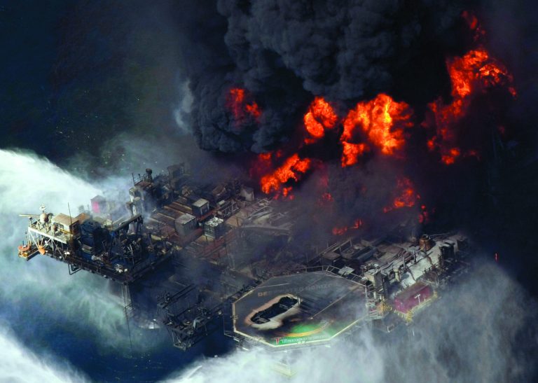 FILE - In this April 21, 2010 file aerial photo, the Deepwater Horizon oil rig burns in the Gulf of Mexico. The Justice Department has reached a $1.4 billion settlement with Transocean Ltd., the owner of the drilling rig that sank after an explosion killed 11 workers and spawned the massive 2010 oil spill in the gulf. On Thursday, Jan. 3, 2013, two people with knowledge of the negotiations say Switzerland-based Transocean would pay the money to resolve the department's civil and criminal probe of the company's role in the Deepwater Horizon disaster. (AP Photo/Gerald Herbert, File)