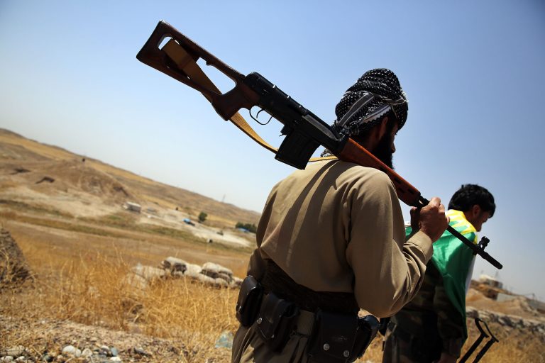 Soldiers with the Kurdish peshmerga walk at an outpost on the edges of Kirkuk on July 3, 2014 in Kirkuk, Iraq. (Photo by Spencer Platt/Getty Images)