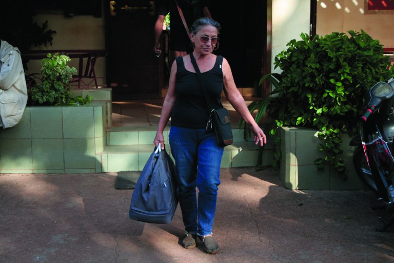 French citizen Nicole Obre Toure carries a bag to her car as she prepares to leave the region where she has lived for 12 years, in Segou, central Mali, Monday, Jan. 14, 2013. As Islamist militants gained ground Monday morning, Toure decided to move from the village where she lives into Segou, the regional capital. Once there, however, she learned that the French government had ordered the immediate evacuation of French citizens from the area. Despite intensive aerial bombardments by French warplanes, Islamist insurgents grabbed more territory in Mali Monday and moved closer to the capital, French and Malian authorities said. (AP Photo/Harouna Traore)