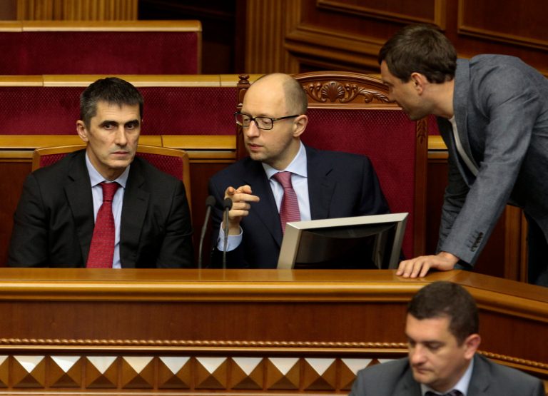 Ukrainian Prime Minister Arseniy Yatsenyuk, center,  and  new Ukrainian prosecutor-general Vitaly Yarema, left,   during a session of the parliament in Kiev, Ukraine, Thursday, June 19, 2014. The Ukrainian parliament on Thursday approved Ukraine's new foreign minister, prosecutor-general and National Bank Chief.  (AP Photo/Sergei Chuzavkov)