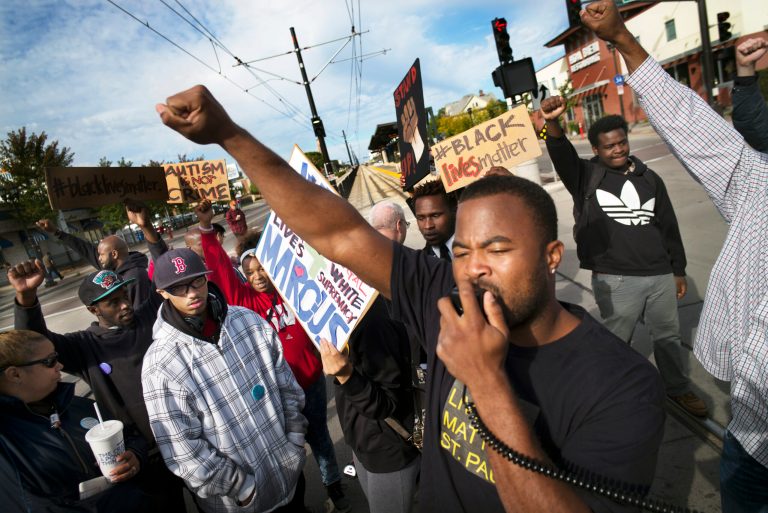 Near the Lexington light rail station in St. Paul, Minn., protesters with Black Lives Matters block traffic to and from TCF Bank Stadium before an NFL football game between the Minnesota Vikings and the Detroit Lions on Sunday, Sept. 20, 2015. (Richard Tsong-Taatarii/Star Tribune via AP)
