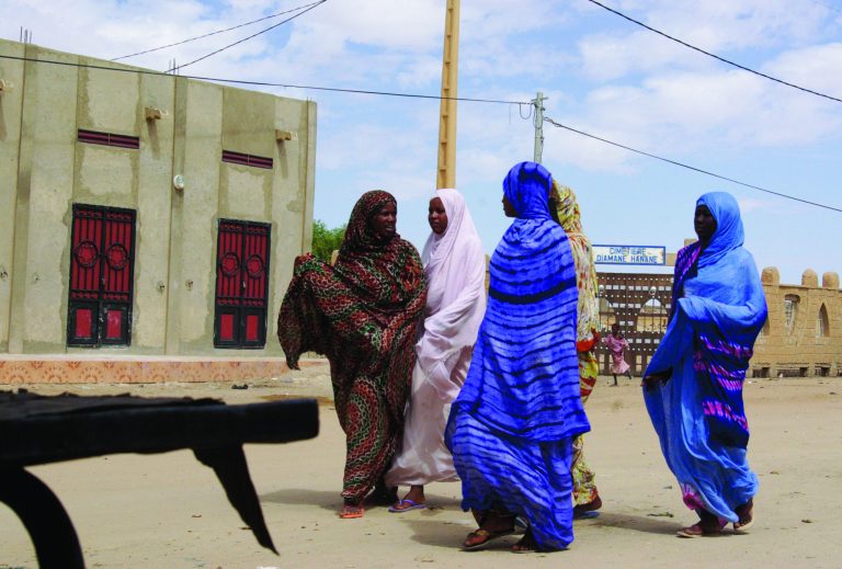 FILE - In this Oct. 18, 2012 file photo, women wearing veils as mandated by Islamist group Ansar Dine, walk along a street in Timbuktu, Mali. The Mali army attacked Islamist rebels with heavy weapons in the center of the country which divides the insurgent-held north and the government-controlled south, government officials said Thursday, Jan. 10, 2013. (AP Photo/File)