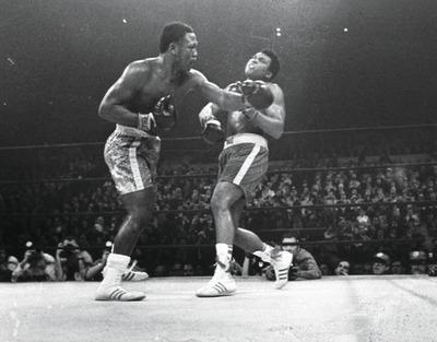 AP file photo
Joe Frazier, left, knocked down Muhammad Ali with his vintage left hook during the 15th round of the