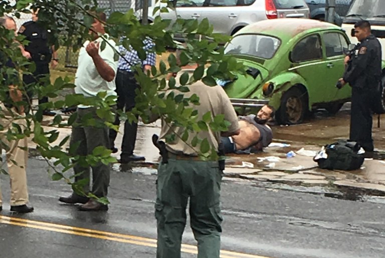 Ahmad Khan Rahami is taken into custody after a shootout with police Monday in Linden, N.J. (Moshe Weiss via AP)