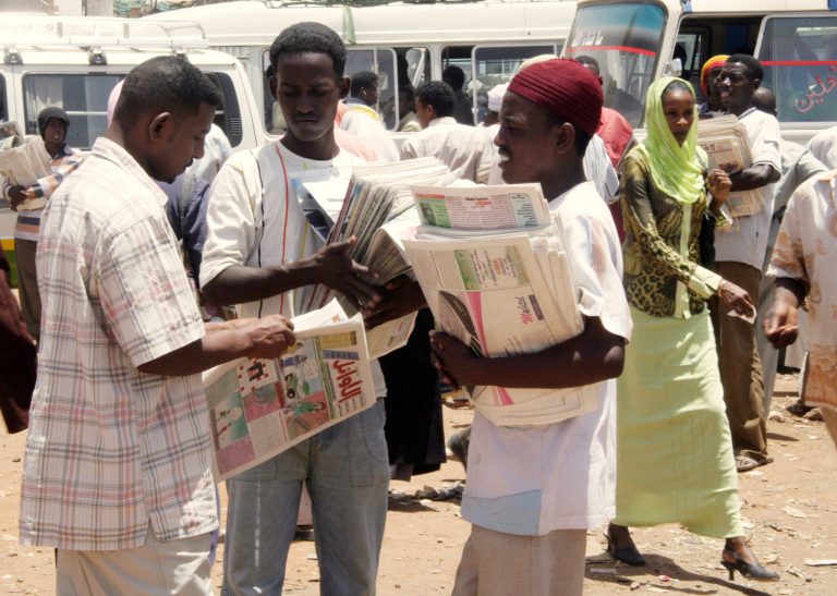 Sudanese newspaper vendors talk to each other at a bus station in Khartoum, Tuesday, Nov. 27, 2007. (AP File Photo/Abd Raouf)