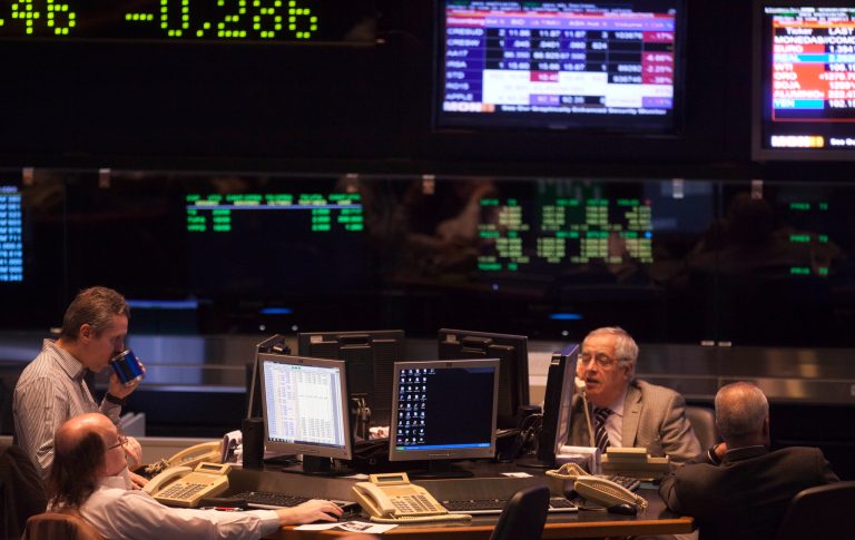 Brokers work at the Buenos Aires Stock Exchange in Buenos Aires, Argentina, Tuesday, June 17, 2014. Argentina's President Cristina Fernandez is refusing to go along with a U.S. judge's ruling requiring repayment of defaulted bonds. The Merval stock index dropped after Monday's court decision, its largest one-day loss in more than six months, and the value of Argentina's currency went down on the black market.  (AP Photo/Eduardo Di Baia)