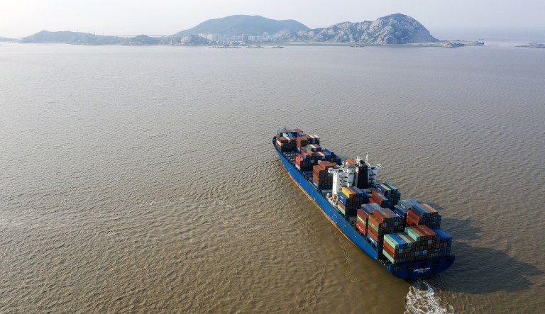 The Emirates Hana container ship sails near the Yangshan Deepwater Port, operated by Shanghai International Port Group Co. (SIPG), in this aerial photograph taken in Shanghai, China, on Friday, May 10, 2019.