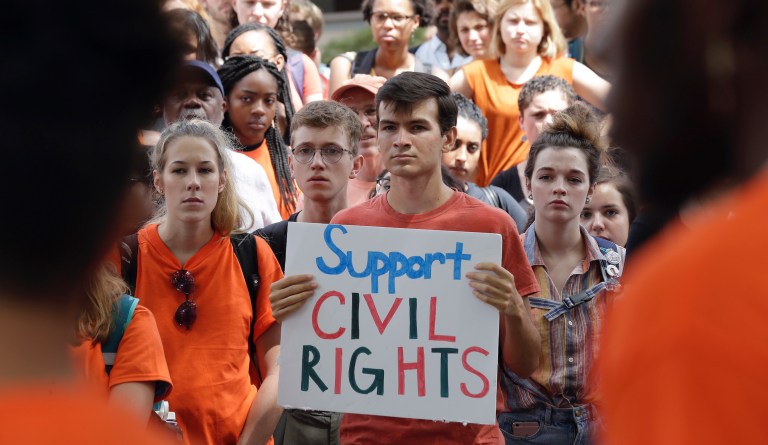 Protesters listen during a gathering in the pit at the University of North Carolina to protest the confederate monument "Silent Sam" and the recent concerns over the UNC Center for Civil Rights in Chapel Hill, N.C., Thursday, Aug. 31, 2017. 
