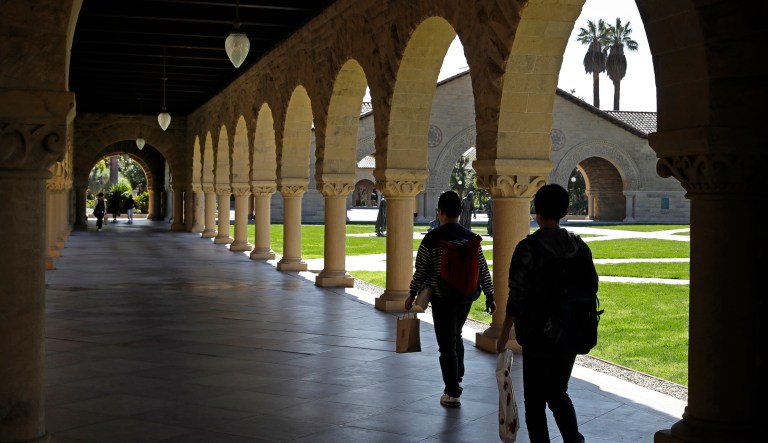 People walk on the Stanford University campus Thursday, March 14, 2019, in Santa Clara, Calif.