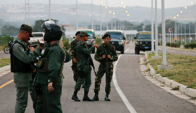 Members of the Venezuelan army and National Guard block the main access to the Tienditas International Bridge that links Colombia and Venezuela, near Urena, Venezuela, Thursday, Feb. 7, 2019.
