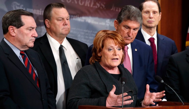 Sen. Heidi Heitkamp, D-N.D., speaks, accompanied by moderate Senate Democrats including Sen. Joe Donnelly, D-Ind., Sen. Jon Tester, D-Mont., Sen. Joe Manchin, D-W.Va., and Sen. Ron Wyden, D-Ore., during a news conference, Tuesday, Nov. 28, 2017.
