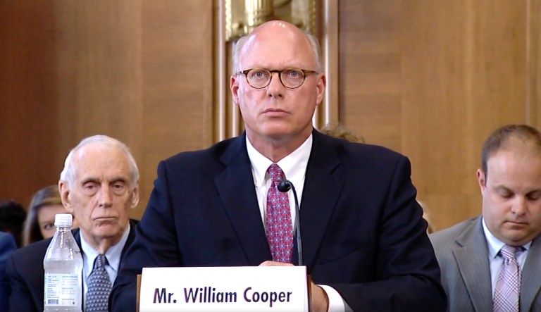William Cooper, President Trump's nominee to become the Energy Department's general counsel, is pictured (center) at a hearing.