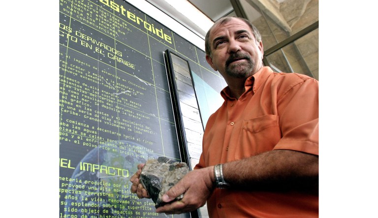 Manuel Iturralde investigator at the Natural History Museum of Havana, Cuba, holds a fragment of a meteor, Tuesday, May 27, 2003, which, according to his reasearch, 65 millions of years ago, impacted in Chucxulub, Yucatan, Mexico, killing the dinosaurs. 