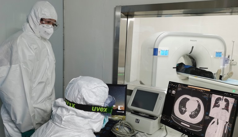 In this Sunday, Feb. 9, 2020, photo released by Xinhua News Agency, doctors scan a patient's lungs at Huoshenshan temporary hospital built for patients diagnosed with coronavirus in Wuhan in central China's Hubei province. Mainland China has reported another rise in cases of the new virus after a sharp decline the previous day, while the number of deaths grow over 900, with at least two more outside the country.