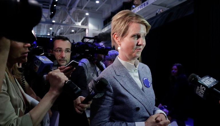 New York gubernatorial nominee Cynthia Nixon, right, answers questions for the media as she leaves the New York state Democratic convention, Wednesday, May 23, 2018, in Hempstead, N.Y.