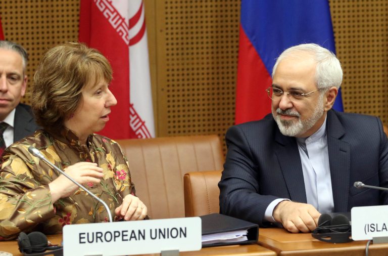 European foreign policy chief Catherine Ashton, left, and Iranian Foreign Minister Mohamad Javad Zarif, right, wait for the start of closed-door nuclear talks in Vienna, Austria, Wednesday, May 14, 2014. The talks between Iran and six world powers have entered an ambitious new stage with the two sides sitting down to start drafting the text of a final deal. (AP Photo/Ronald Zak)