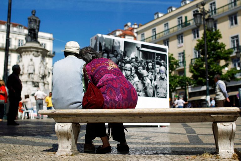 In this photo taken on May 14, 2014, Leoncio Sousa, 76, left, and his wife Cecilia Sousa, 71, sit in a bench before taking part in a protest against pension cuts, in Lisbon. Leoncio, who worked during 42 years as engineer at Lisbon's subway, said that his pension has been cut by 45 percent early 2014. A thousand days on from its near-economic collapse, Portugal is ready to stand on its own again. On Saturday, May 17, 2014,  after an internationally-mandated makeover, Portugal will become the second euro country, after Ireland, to officially shake off its bailout shackles. (AP Photo/Francisco Seco)