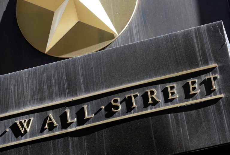 FILE - This March 4, 2013 file photo shows a sign for Wall Street on the side of building near the New York Stock Exchange. The stock market moved lower Friday, Sept. 12, 2014, heading for its first weekly loss since the start of August. (AP Photo/Mark Lennihan, File)