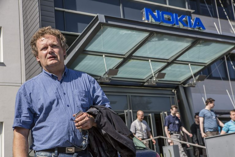   Union steward Jarmo Talvitie talks to media as Nokia employees leave a personnel briefing in Tampere, Finland, Thursday June 14, 2012. Nokia Corp. will lay off 10,000 jobs globally and close plants by the end of 2013, the company said Thursday June 14, 2012, in a further drive to save costs. The cuts mean that it will close some research and development projects, including in Ulm, Germany, and Burnaby, Canada. (AP Photo/Lehtikuva, Jukka Toyli) FINLAND OUT  