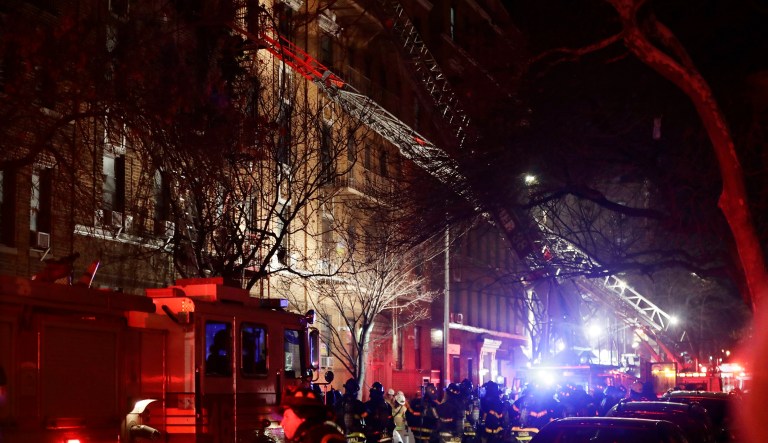 Firefighters respond to a building fire Thursday in the Bronx borough of New York. The Fire Department of New York says a blaze raging in the Bronx apartment building has seriously injured more than a dozen of people. (AP Photo/Frank Franklin II)