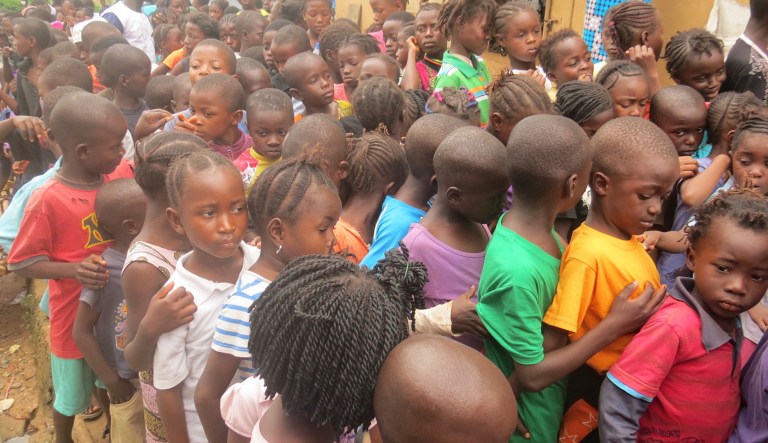 In this photo taken on Saturday, Aug. 19, 2017, children displaced by heavy floods and mudslides wait for food ration in Freetown, Sierra Leone. Last year, UNICEF estimated there are 140 million orphans worldwide and that number is growing. (AP Photo/ Manika Kamara)