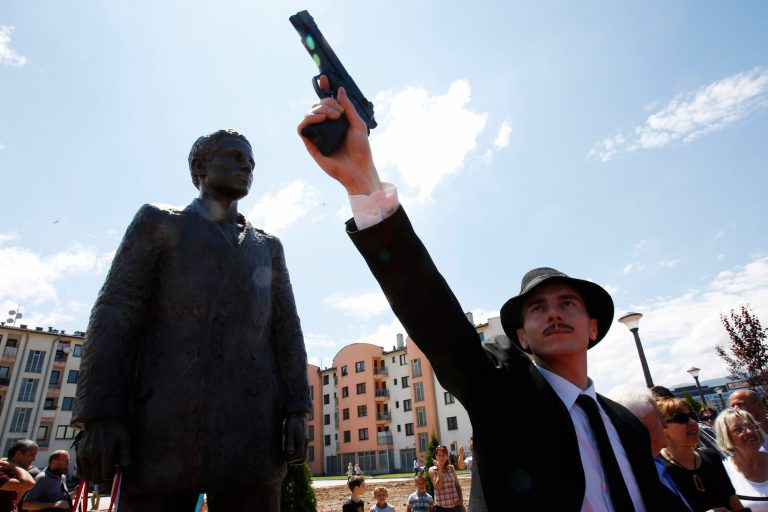 Bosnian actor Jovan Mojsilovic poses with a plastic replica gun  during ceremony of unveiling statue of Gavrilo Princip in Istocno Sarajevo, on Friday, June 27, 2014. Marking the centennial of the beginning of World War I in their own way, Bosnian Serbs have unveiled a monument of Gavrilo Princip in the Eastern part of Sarajevo to the man who ignited the war by assassinating the Austro-Hungarian crown prince on June 28, 1914.(AP Photo/Amel Emric)