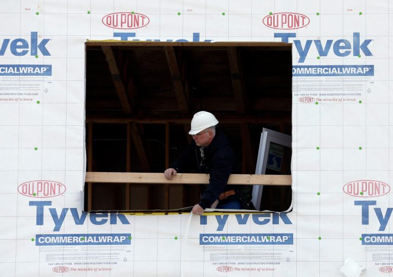 In this March 26, 2014 photo, a builder works on a home under construction in northwest Chicago. U.S. homebuilders' confidence in the housing market rose modestly in April but remained at low levels for the third straight month, constrained by tight credit for home buyers and a shortage of workers and available land, according to a National Association of Home Builders report released Tuesday, April 15, 2014. (AP Photo/Nam Y. Huh)