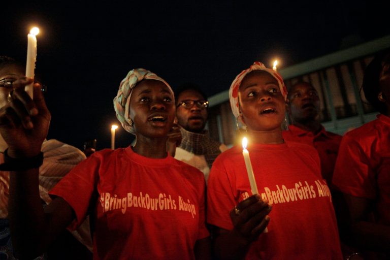 People hold candle light during a vigil to mark one month after the girls of government secondary school Chibok were kidnapped, in Abuja, Nigeria, Wednesday, May 14, 2014. Nigeria's government is ruling out an exchange of more than 270 kidnapped schoolgirls for detained Islamic militants, Britain's top official for Africa said Wednesday. Boko Haram abducted more than 300 schoolgirls from the school in Chibok in the northeastern state of Borno on April 15. (AP Photo/Sunday Alamba)