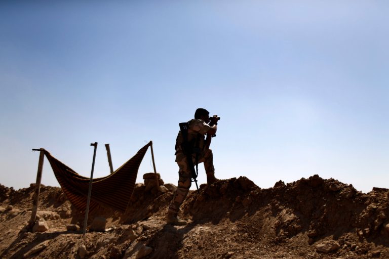 A Kurdish Peshmerga fighter uses binoculars to check on ISIS positions on the outskirts of Makhmour, 186 miles north of Baghdad, Iraq, Saturday, Sept. 6, 2014. (AP Photo/ Marko Drobnjakovic)