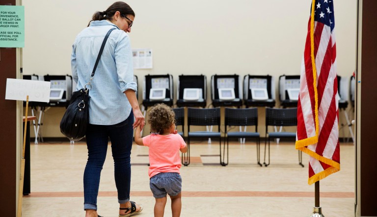 Melissa Painter walks with her one year-old daughter Elle to vote in Georgia's 6th Congressional District special election at a polling site in Sandy Springs, Ga., Tuesday, June 20, 2017. The most expensive House race in U.S. history heads to voters Tuesday in suburban Atlanta. Either Republican Karen Handel will claim a seat that's been in her party's hands since 1979 or Democrat Jon Ossoff will manage an upset that will rattle Washington ahead of the 2018 midterm elections. (AP Photo/David Goldman)