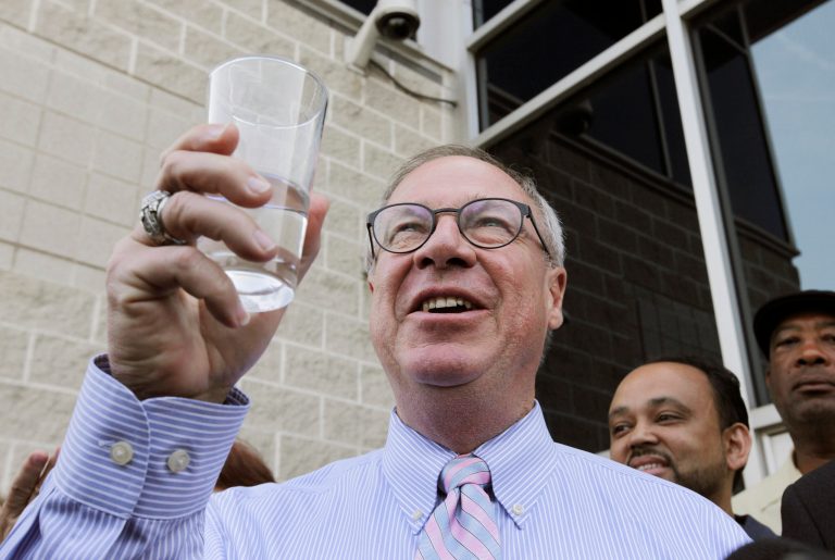 Toledo Mayor D. Michael Collins raises a glass of tap water before drinking it during a news conference in Toledo, Ohio, Monday, Aug. 4, 2014. A water ban that had hundreds of thousands of people in Ohio and Michigan scrambling for drinking water has been lifted, Collins announced Monday. (AP Photo/Paul Sancya)