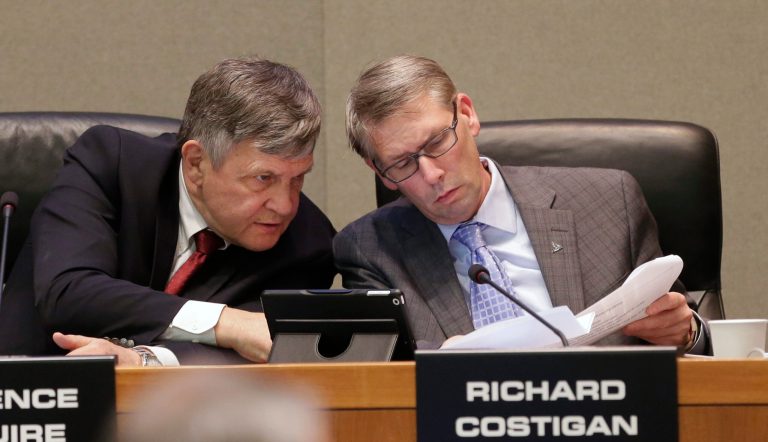 Terrence McGuire, who is a proxy for California Public Employees Retirement System Board Member, State Controller John Chiang, talks with board member Richard Costigan, during a meeting in Sacramento, Calif., Tuesday. (AP/Rich Pedroncelli)
