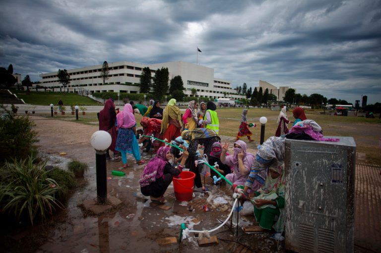 Supporters of Pakistan's fiery Muslim cleric Tahir-ul-Qadri wash their laundry in front of the parliament building where they are camping in Islamabad, Pakistan, Wednesday, Sept. 3, 2014. Anti-government demonstrators led by opposition politician Imran Khan and Qadri converged on the capital in mid-August, demanding  Prime Minister Nawaz Sharif's ouster over alleged fraud in last year's election. Their protests turned violent this past weekend, when clashes between demonstrators and security forces killed many people and wounded some hundreds. (AP Photo/B.K. Bangash)