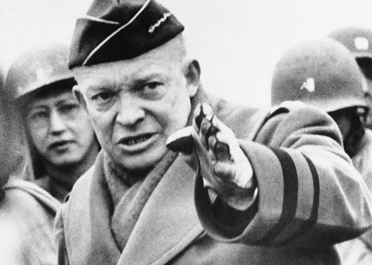 Gesturing as he talks, General Dwight D. Eisenhower, leader of Allied forces organizing in Britain for the second front, watches maneuvers on a miniature tank range somewhere in Britain on March 13, 1944. (AP Photo/Pool)