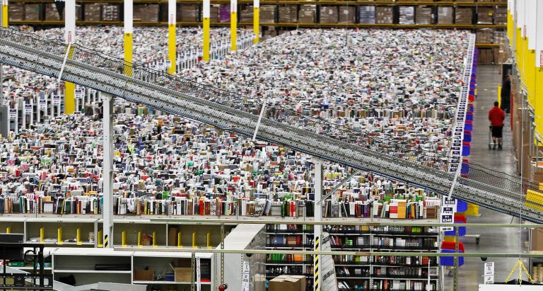FILE - In this  Monday, Nov. 26, 2012, file photo, an employee walks a wide isle at Amazon.com's 1.2 million square foot fulfillment center, in Phoenix.  Millions of shoppers are expected to click on items on Monday, Dec. 2, 2013,  as retailers rev up deals to grab online holiday shopping dollars on the first working day after the busy holiday weekend. (AP Photo/Ross D. Franklin, File)