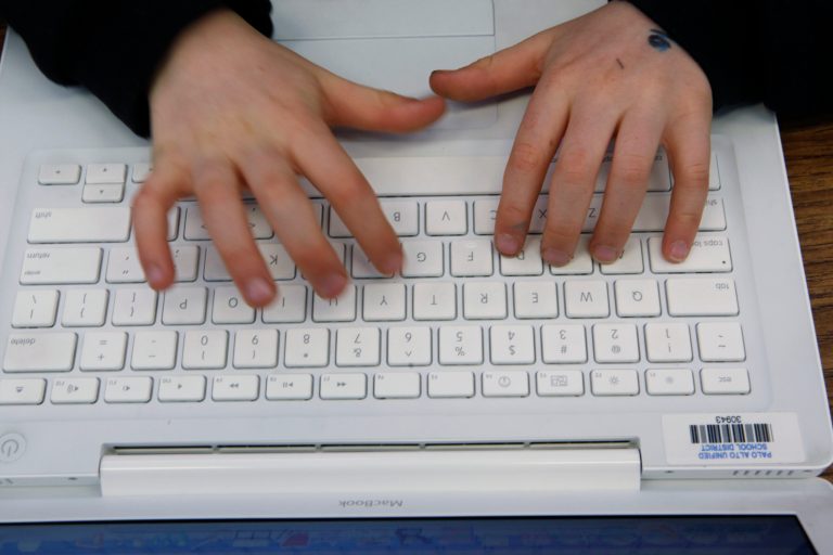 FILE - In this Feb. 22, 2010 file photo, a student uses an Apple MacBook laptop in his class in Palo Alto, Calif. New warnings are emerging of a security flaw known as the 
