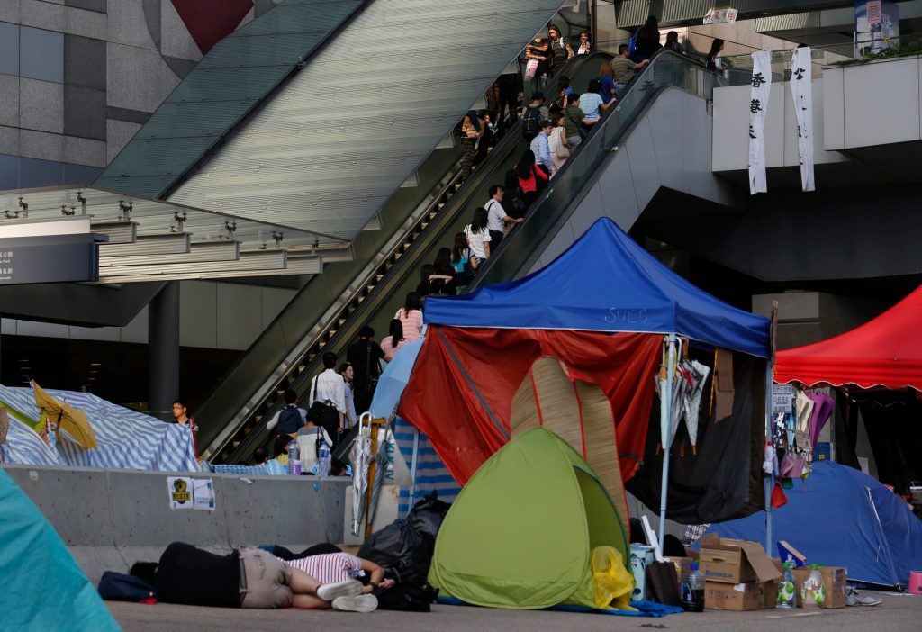 Hong Kong officials resume work as protests thin