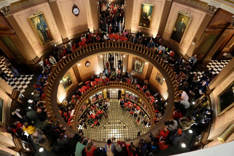   Protesters gather for a rally in the State Capitol rotunda in Lansing, Mich., Tuesday, Dec. 11, 2012. The crowd is protesting right-to-work legislation passed last week. Michigan could become the 24th state with a right-to-work law next week. Rules required a five-day wait before the House and Senate vote on each other's bills; lawmakers are scheduled to reconvene Tuesday and Gov. Snyder has pledged to sign the bills into law. (AP Photo/Paul Sancya)  